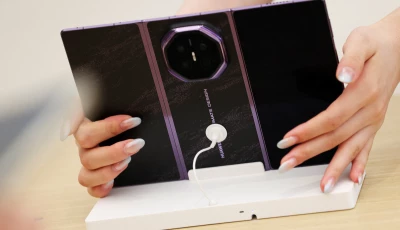 a staff member holds a newly unveiled huawei mate xt2 foldable smartphone displayed at a huawei store in beijing china september 7 2026 reuters