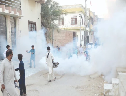 children in a hyderabad neighbourhood play in the mist of the fumigation spray as government officials try to contain the epidemic in the province s second largest urban centre photo nni