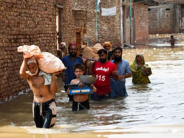 people wade through a flooded street as they carry a woman towards the hospital at latifabad hyderabad pakistan august 22 2025 photo reuters people wade through a flooded street as they carry a woman towards the hospital at latifabad hyderabad pakistan august 22 2025 photo reuters