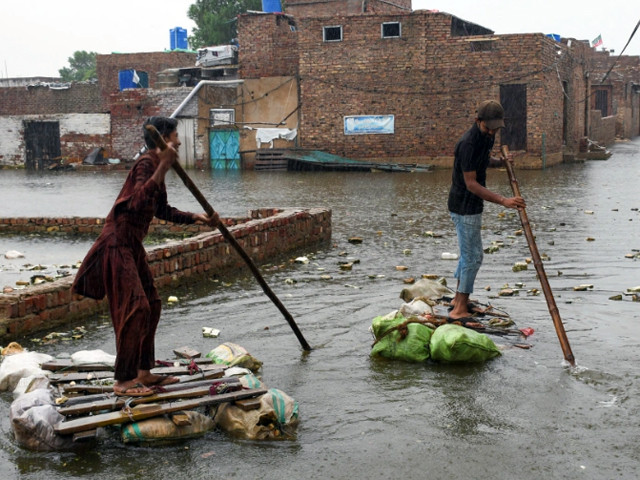 boys paddle through flood waters in hyderabad photo reuters