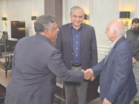 icc deputy chairman imran khawaja and bcb president aminul islam shake hands as pcb chairman mohsin naqvi looks on during a meeting at the pcb headquarters in lahore photo express