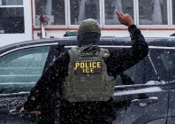 an immigration and customs enforcement agent raises a finger moments after detaining a man during an immigration raid in minneapolis minnesota us january 18 2026 photo reuters