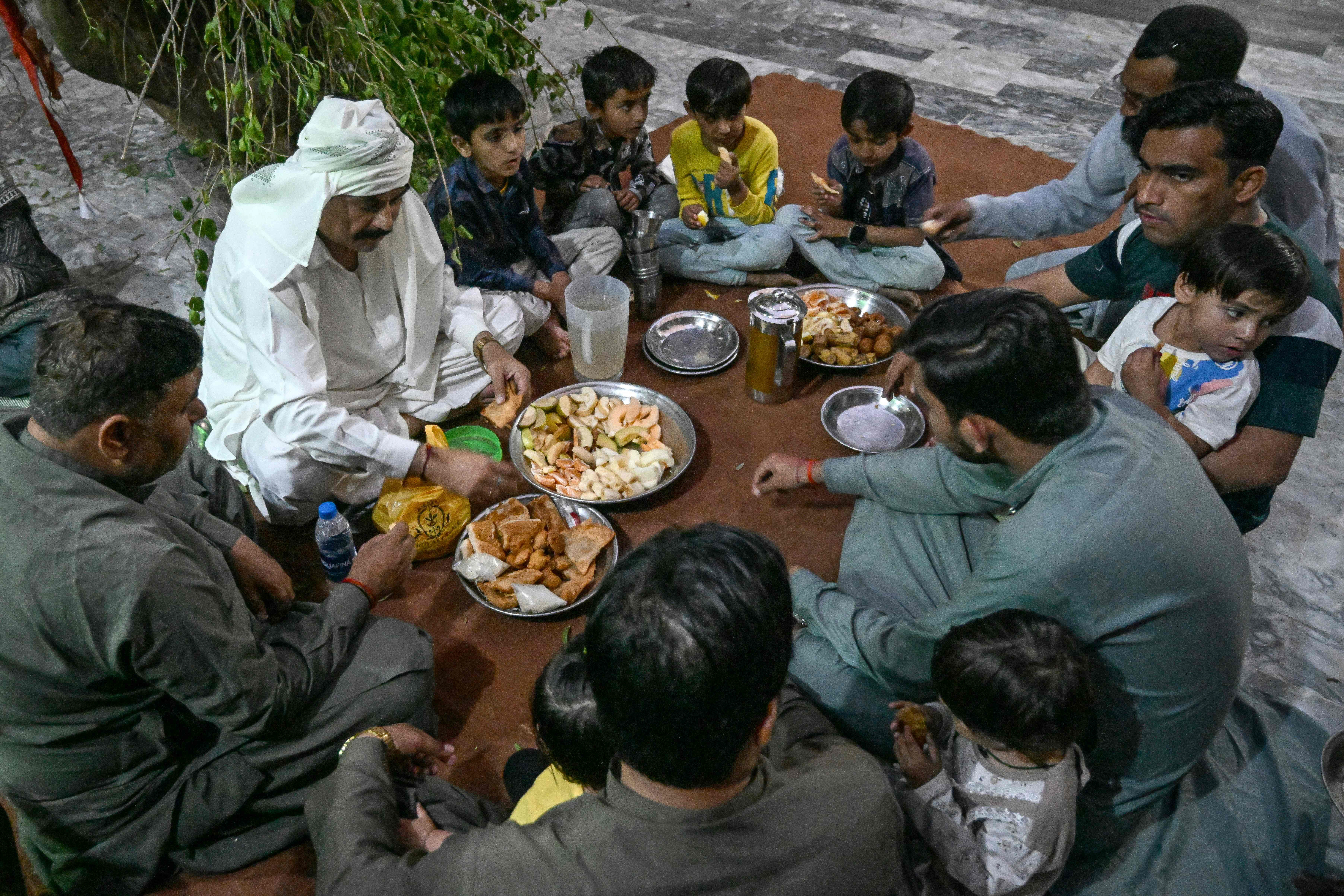 This photograph taken on February 26, 2026 shows Hindu men preparing Iftar meals during the Islamic holy fasting month of Ramadan, inside a Sufi shrine at Mithi in the Tharparkar district of Sindh province. Photo: AFP