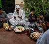 this photograph taken on february 26 2026 shows mohan lal malhi 2l a hindu caretaker of a sufi shrine breaking his fast during the islamic holy fasting month of ramadan at mithi in the tharparkar district of sindh province photo afp