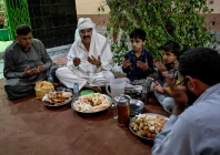 this photograph taken on february 26 2026 shows mohan lal malhi 2l a hindu caretaker of a sufi shrine breaking his fast during the islamic holy fasting month of ramadan at mithi in the tharparkar district of sindh province photo afp