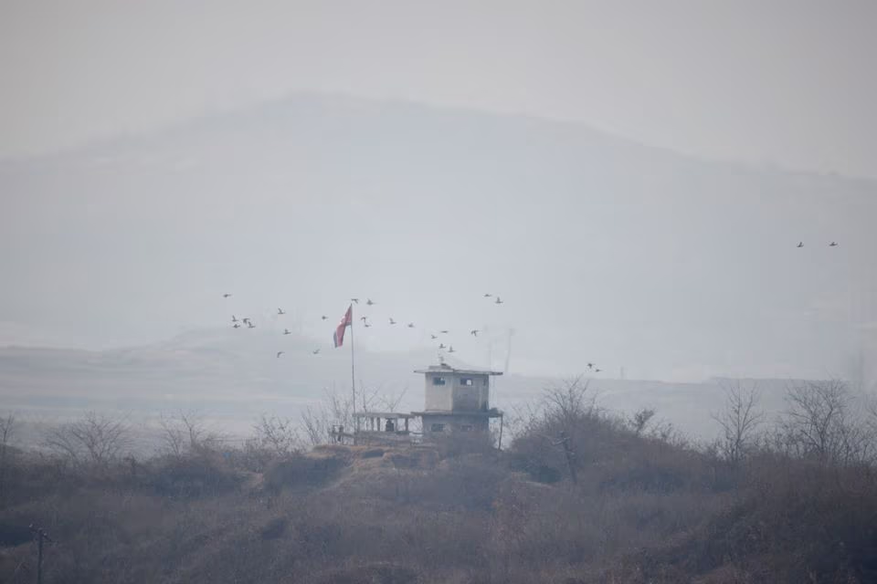 birds fly over a north korean guard post at the propaganda village of gijungdong in north korea seen near the truce village of panmunjom inside the demilitarized zone dmz separating the two koreas february 7 2023 photo reuters