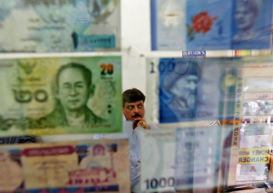 a man watches television inside his currency exchange shop in new delhi august 30 2013 photo reuters file