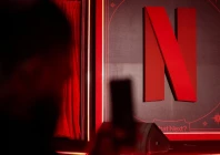 a man takes a photograph next to a netflix logo during an event in mumbai india february 3 2026 reuters