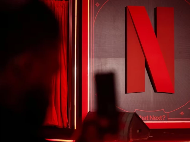 a man takes a photograph next to a netflix logo during an event in mumbai india february 3 2026 reuters a man takes a photograph next to a netflix logo during an event in mumbai india february 3 2026 reuters