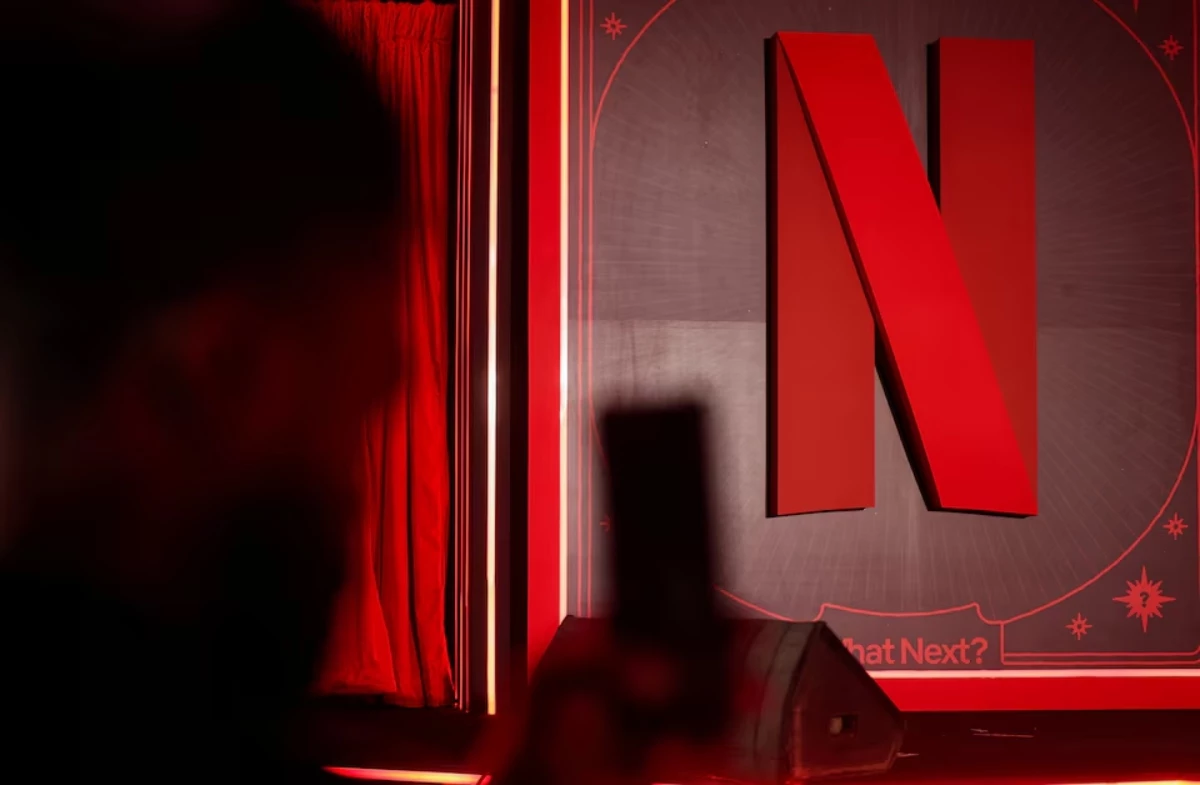 a man takes a photograph next to a netflix logo during an event in mumbai india february 3 2026 reuters