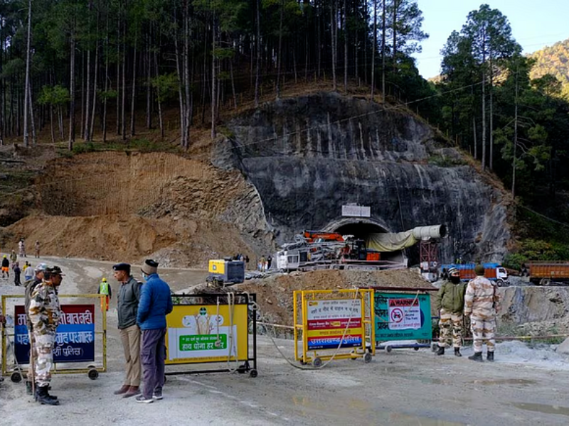 police officers stand guard next to a barricade past the entrance of a tunnel where 40 road workers are trapped after a portion of the tunnel collapsed in uttarkashi in the northern state of uttarakhand india november 16 2023 photo reuters