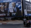 people walk next to a campaign banner of netanyahu s likud party ahead of the israeli parliamentary election in bnei brak israel october 25 2026 reuters
