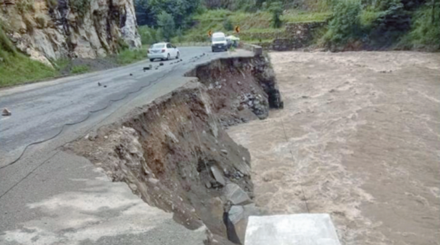 a part of the main alpuri besham road has been washed away by floodwater during the third spell of monsoon rains photo nni a part of the main alpuri besham road has been washed away by floodwater during the third spell of monsoon rains photo nni
