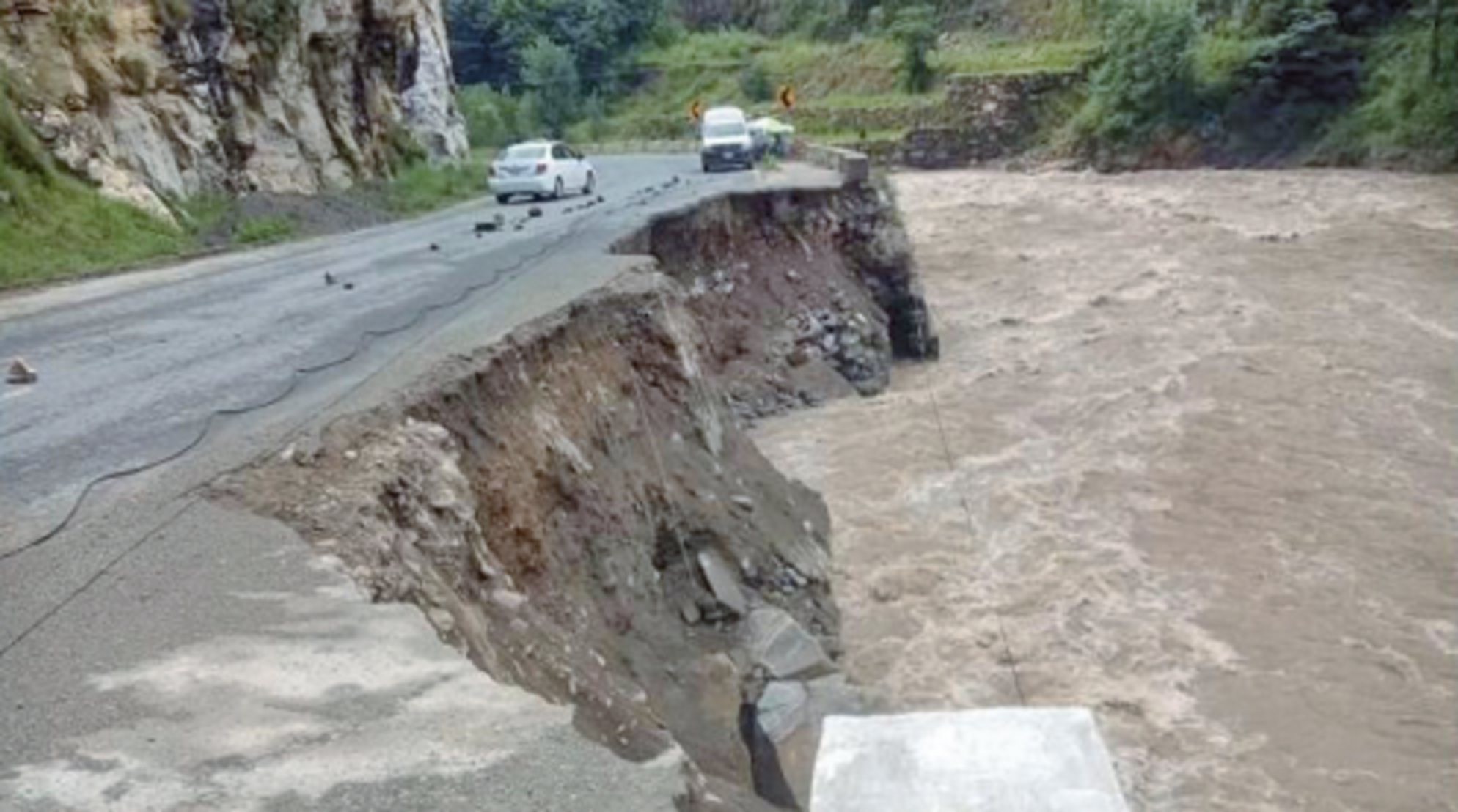 a part of the main alpuri besham road has been washed away by floodwater during the third spell of monsoon rains photo nni