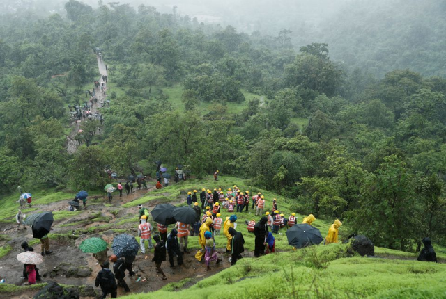 national disaster response force ndrf personnel and other volunteers climb up a mountain to reach the site of a landslide at a village in raigad in the western state of maharashtra india july 20 2023 photo reuters national disaster response force ndrf personnel and other volunteers climb up a mountain to reach the site of a landslide at a village in raigad in the western state of maharashtra india july 20 2023 photo reuters