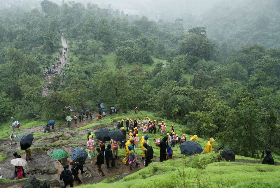 national disaster response force ndrf personnel and other volunteers climb up a mountain to reach the site of a landslide at a village in raigad in the western state of maharashtra india july 20 2023 photo reuters