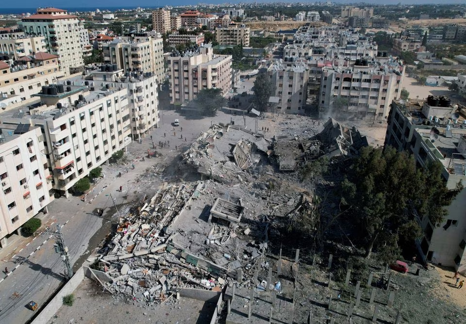 palestinians gather around residential buildings destroyed in israeli strikes in zahra city amid the ongoing conflict between israel and hamas in southern gaza city october 19 2023 photo reuters