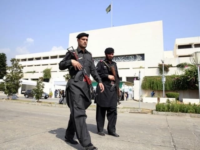 frontier constabulary fc personnel walk past the parliament building photo reuters frontier constabulary fc personnel walk past the parliament building photo reuters