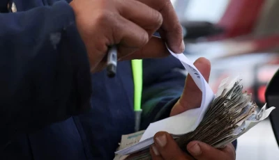 a worker counts egyptian pounds and issues a receipt after filling a car s tank at a chillout petrol station as egypt raises domestic fuel prices by up to 17 amid global energy turmoil and the expanding us israeli conflict with iran in cairo egypt march 10 2026 photo reuters