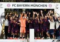 bayern munich s manuel neuer lifts the trophy with teammates after winning the supercup final photo reuters