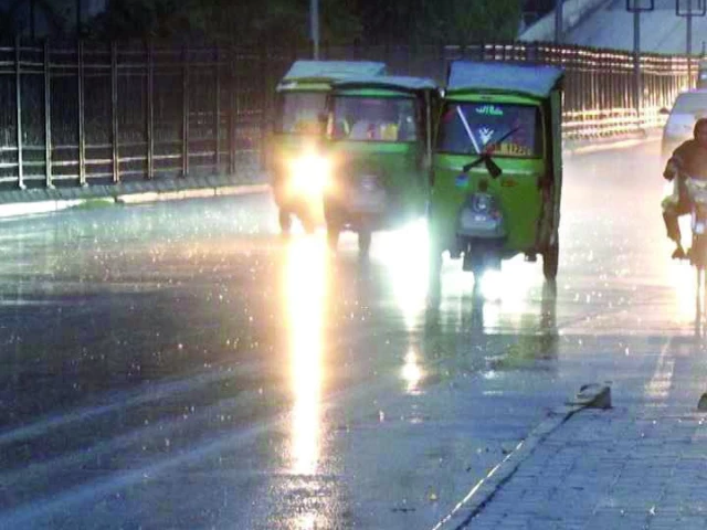 rickshaws and motorbikes navigate a rain soaked road in peshawar as evening showers bring relief from the heat and cool down the city photo express
