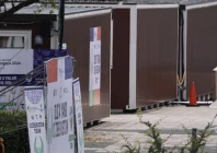 a man walks past temporary container huts being used to house athletes for the 2026 asian games at the garden pier in nagoya photo afp a man walks past temporary container huts being used to house athletes for the 2026 asian games at the garden pier in nagoya photo afp