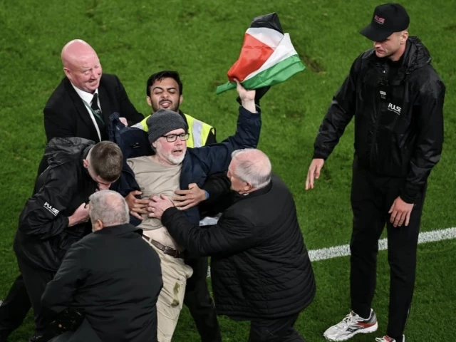 a protester holding a palestine flag is removed from the pitch at the aviva stadium photo afp a protester holding a palestine flag is removed from the pitch at the aviva stadium photo afp