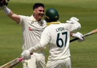 australia s matt renshaw celebrates his century with his teammate nathan lyon on day two of the first cricket test match between south africa and australia in durban photo afp