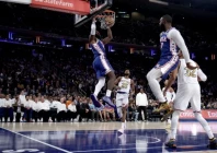 nba superstar lebron james throws down a dunk as phildalphia beat the defending champion new york knicks in his 76ers debut photo afp