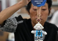 a worker packs merchandise of lionel messi in china photo afp