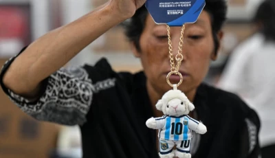 a worker packs merchandise of lionel messi in china photo afp