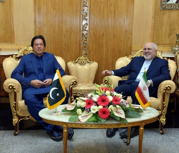 PM Imran Khan with Iranian FM Javad Zarif in Tehran on October 13. PHOTO: PID