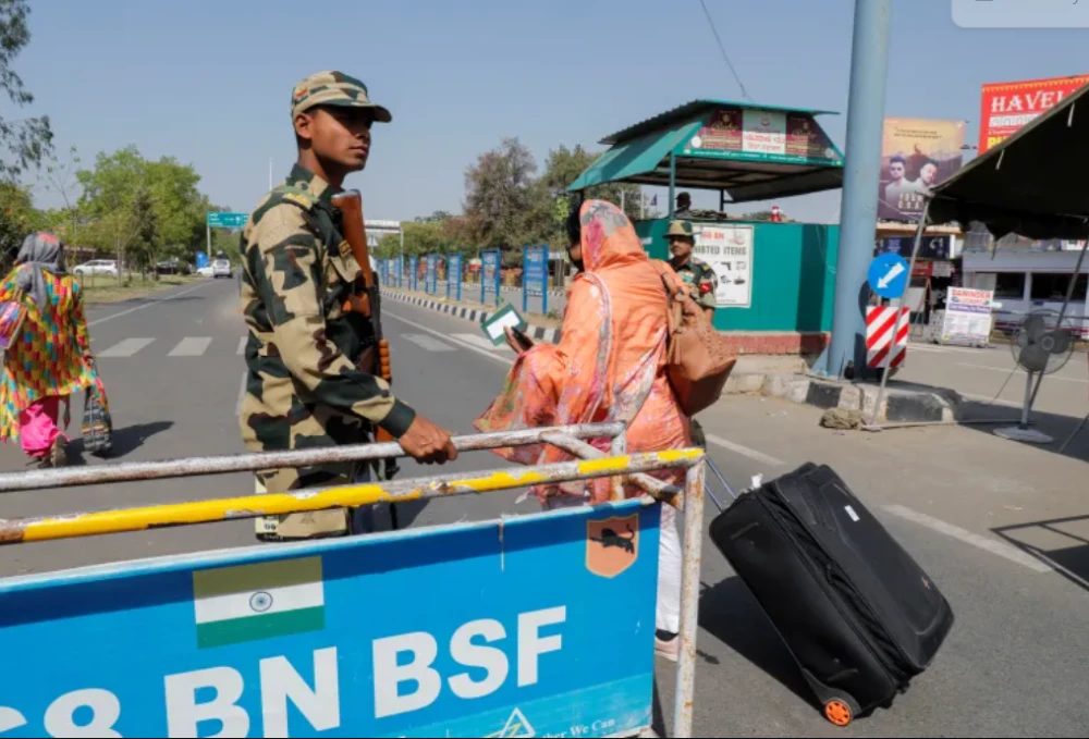 people carry baggage as they cross a border security checkpoint at the attari wagah border crossing on the india pakistan border near amritsar india photo reuters