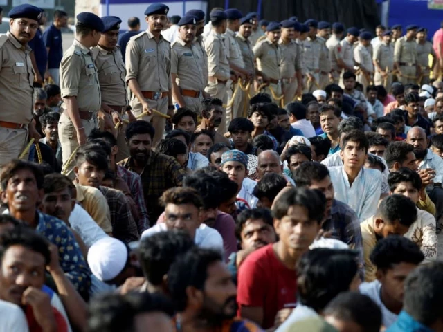 police officers with men they believe to be undocumented bangladeshi nationals after they were detained during raids in ahmedabad india on 26 april photograph photo reuters police officers with men they believe to be undocumented bangladeshi nationals after they were detained during raids in ahmedabad india on 26 april photograph photo reuters