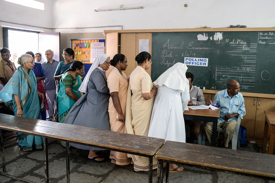 People register to vote at a polling station during India's general election in Hyderabad on April 11, 2019. PHOTO: AFP