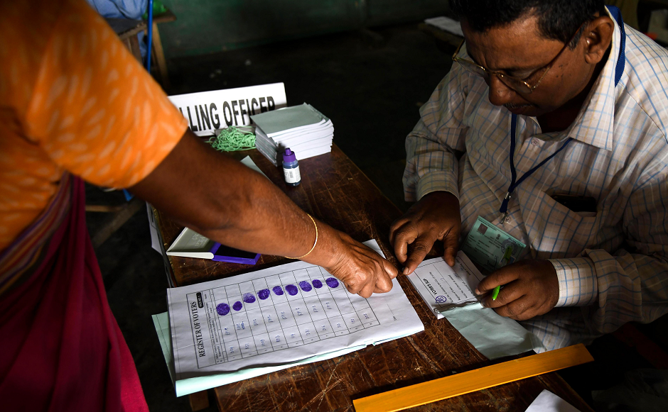 An Indian voter gives her fingerprint as she comes to cast her vote at a polling station during India's general election in Purandudam village, some 140 km from Guwahati, the capital city of India's northeastern state of Assam on April 11, 2019. PHOTO: AFP