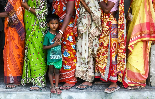 Indian voters queue to cast their ballots on Ghoramara island, south of Kolkata, after a BJP campaign that projected Prime Minister Narendra Modi's strongman image while the Congress-led opposition accused him of divisive policies. PHOTO: AFP