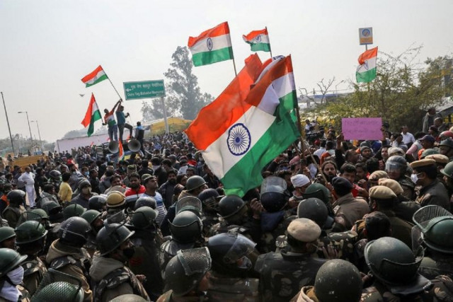 people shout anti farmers slogans and wave india s flags as police officers try to stop them at a site of the protest against farm laws at singhu border near new delhi india january 29 2021 reuters people shout anti farmers slogans and wave india s flags as police officers try to stop them at a site of the protest against farm laws at singhu border near new delhi india january 29 2021 reuters