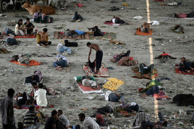 homeless people take rest under a bridge to get respite from the heat on a hot summer afternoon in new delhi photo afp homeless people take rest under a bridge to get respite from the heat on a hot summer afternoon in new delhi photo afp