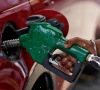 a worker holds a nozzle to pump petrol into a vehicle at a fuel station photo reuters
