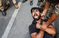 a protester is detained by security personnel during a protest by the cockroach janta party cjp seeking the resignation of india s chief election commissioner gyanesh kumar near the protest site in new delhi india october 11 2026 photo reuters