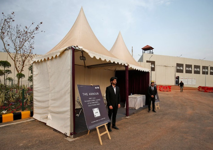 sales representatives stand outside their kiosks inside a luxury residential project by indian property developer dlf in gurugram india february 28 2023 reuters amit dave