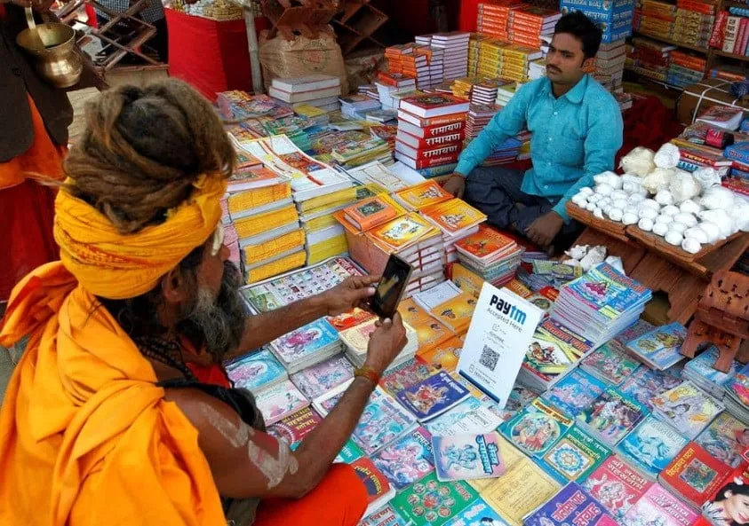 a sadhu or a hindu holy man pays the vendor through paytm a digital wallet company after buying a book during the annual religious festival of magh mela in allahabad india january 26 2017 reuters jitendra prakash a sadhu or a hindu holy man pays the vendor through paytm a digital wallet company after buying a book during the annual religious festival of magh mela in allahabad india january 26 2017 reuters jitendra prakash