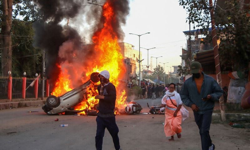 people run past burning vehicles of india s bharatiya janata party bjp mla during a protest to condemn the alleged killing of women and children in imphal capital of india s violence hit northeastern state of manipur on november 16 2024 an indian state riven by months of ethnic tensions imposed an internet shutdown and curfew november 16 after angry protests over the recovery of six bodies of people believed to have been kidnapped by insurgents photo afp