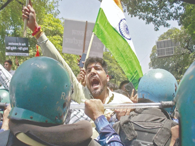 a demonstrator shouts slogans as he is stopped by police during a protest near the pakistan high commission in new delhi photo reuters a demonstrator shouts slogans as he is stopped by police during a protest near the pakistan high commission in new delhi photo reuters