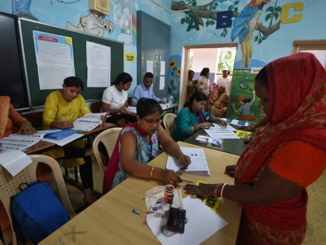 a woman gets her finger marked with ink before she cast her vote inside a polling station during the sixth phase of india s general election in bhubaneswar india may 25 2024 photo reuters