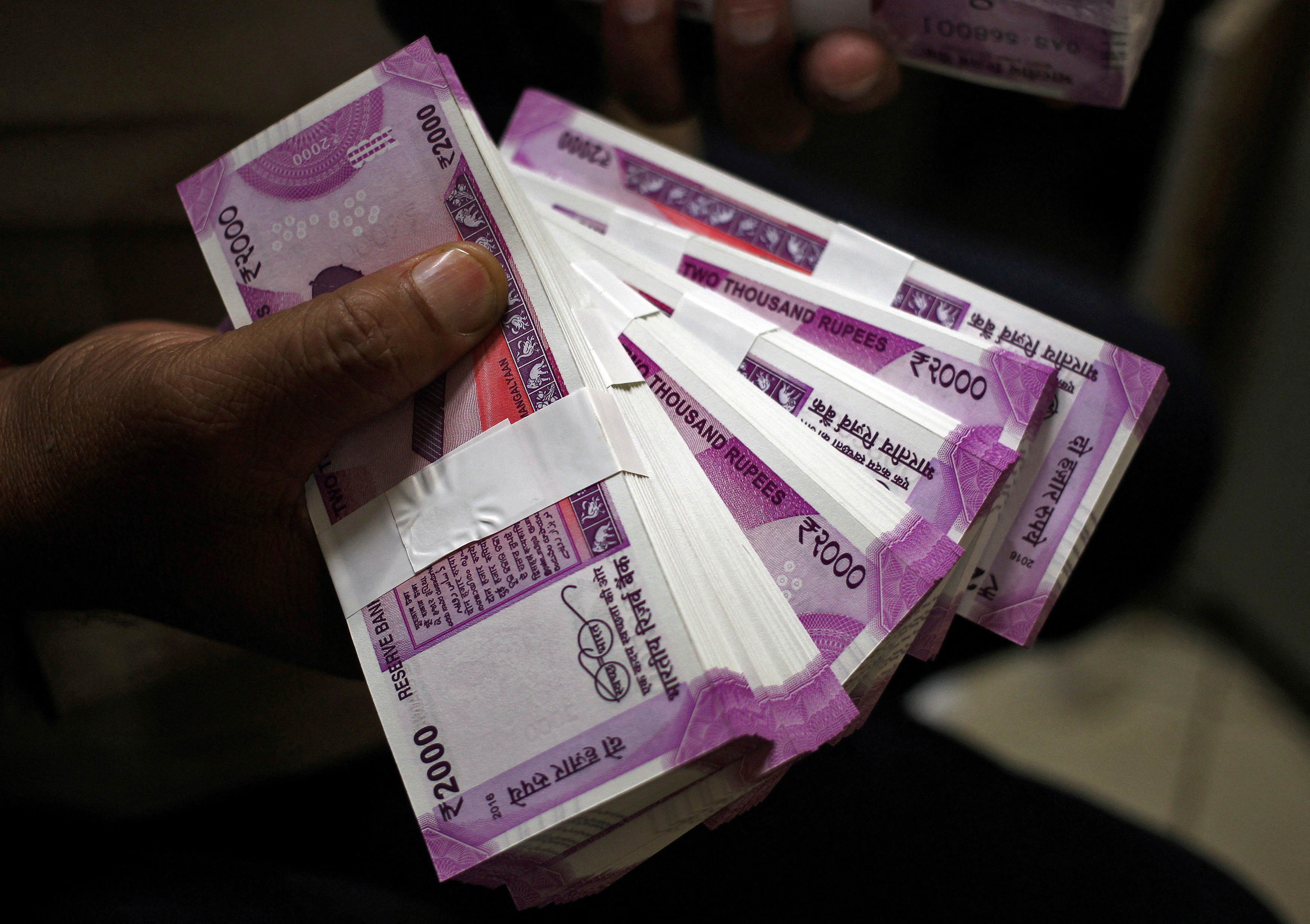 a cashier displays the new 2000 indian rupee banknotes inside a bank in jammu november 15 2016 photo reuters file