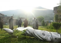 people look at a part of an aircraft in wuyan near indian illegally occupied kashmir s main city of srinagar on may 7 2025 photo afp file