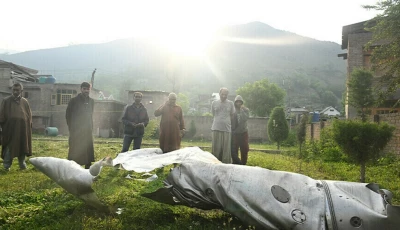 people look at a part of an aircraft in wuyan near indian illegally occupied kashmir s main city of srinagar on may 7 2025 photo afp file