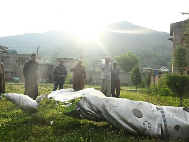 people look at a part of an aircraft in wuyan near indian illegally occupied kashmir s main city of srinagar on may 7 2025 photo afp people look at a part of an aircraft in wuyan near indian illegally occupied kashmir s main city of srinagar on may 7 2025 photo afp
